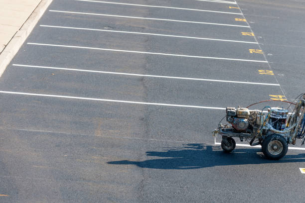 Worker striping a freshly paved surface