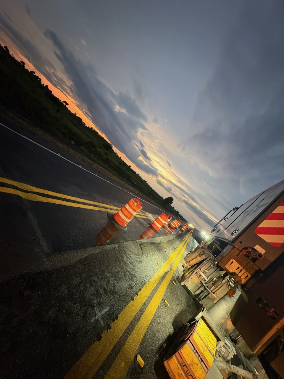 A coned work zone on a Florida state road at dusk