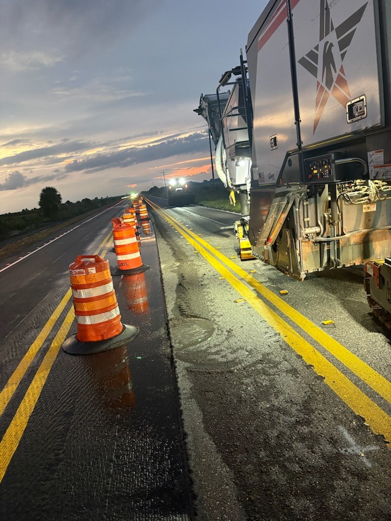 A VLJ Construction milling machine working a Florida state road at dusk